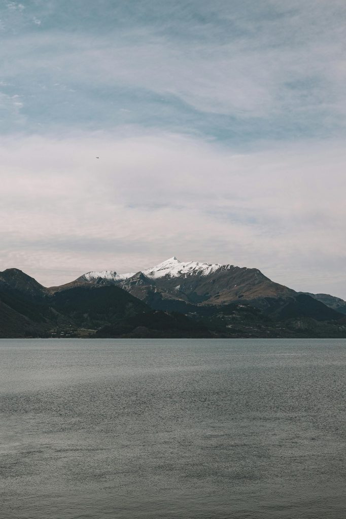 Snow-capped mountains across a calm lake in New Zealand